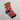 Calcetines de elfo personalizados con la cara del cliente sobre fondo rojo, con el zapato de punta rizada, el caballito de madera y el cascabel