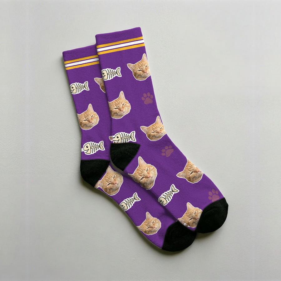 Calcetines personalizados de gato en morado con la cara de un gato naranja, espinas de pescado y huellas estampadas en el tejido